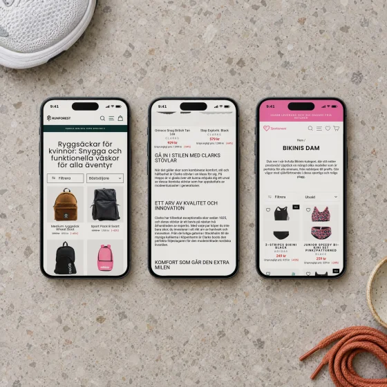 Three phones side by side on a terrazzo table, showing Runforest's women's backpacks, the text on Heppo's Clarks boots page and Sportamore's bikinis.