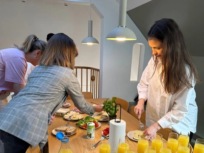 Colleagues setting out breakfast and mimosas in the office kitchen