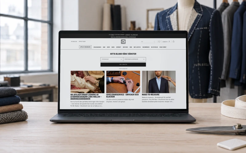 NK's services page filtered to alterations and tailoring in Stockholm, showing four services, on a laptop on a tailor's cutting table beside fabric swatches, shears and a tape measure.