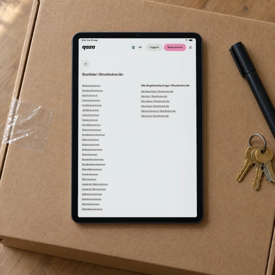 Qasa's sitemap page for Stockholm County, listing every municipality and every home type in the county, on a tablet lying on a moving box.
