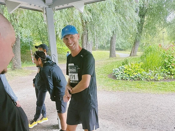 A colleague in running gear smiling before the relay