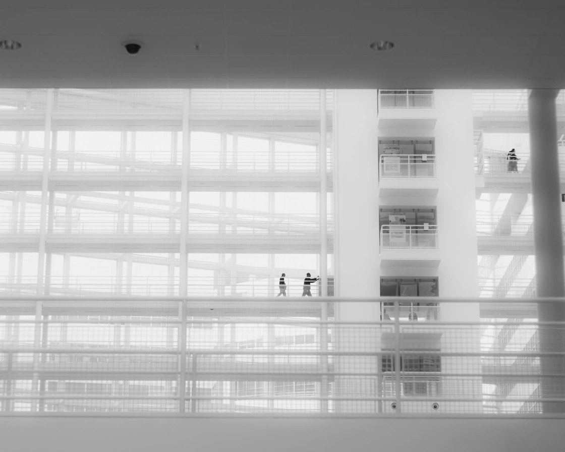 A bright office atrium with glass walkways