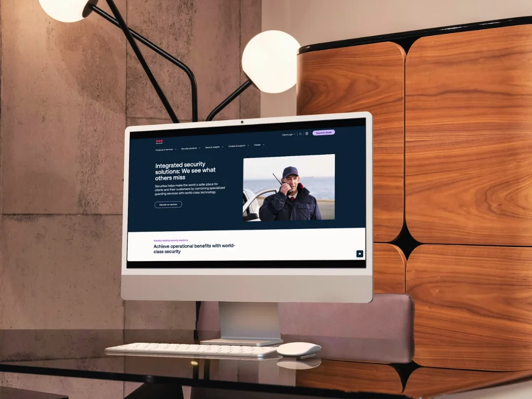 A desktop monitor showing a website on a desk by the window
