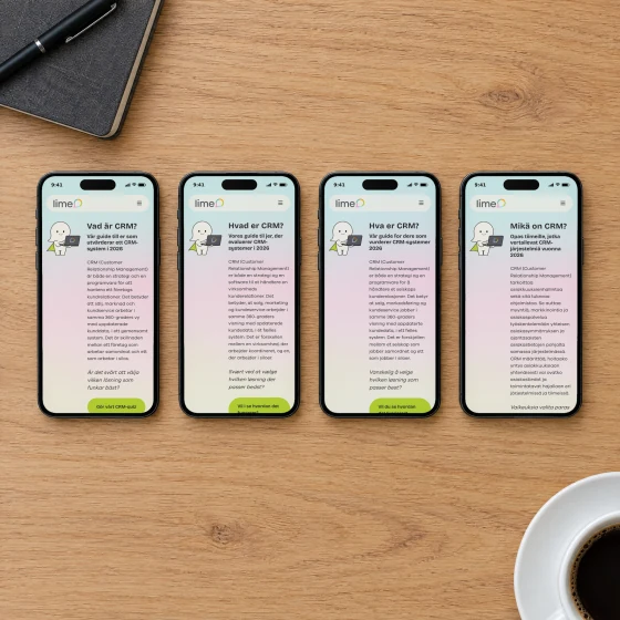 Four phones in a row on an oak conference table, showing Lime's guide “What is CRM?” in Swedish, Danish, Norwegian and Finnish.