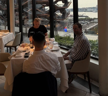Colleagues at dinner by the window in New York during Opticon