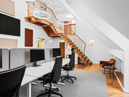 Desks and the wooden spiral staircase at the office on Kungsgatan 24